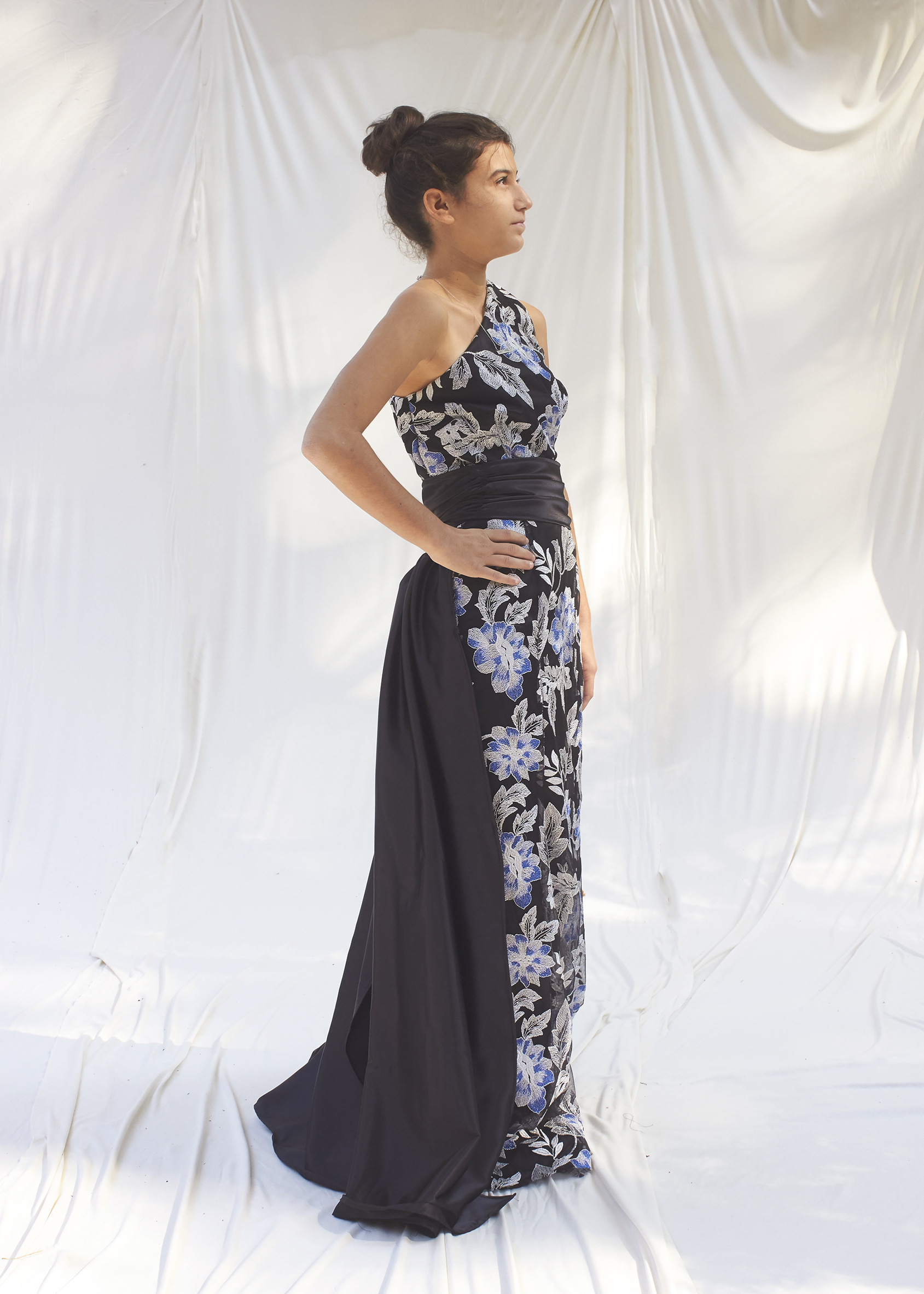 Side view of blue and silver brocade gown and black train