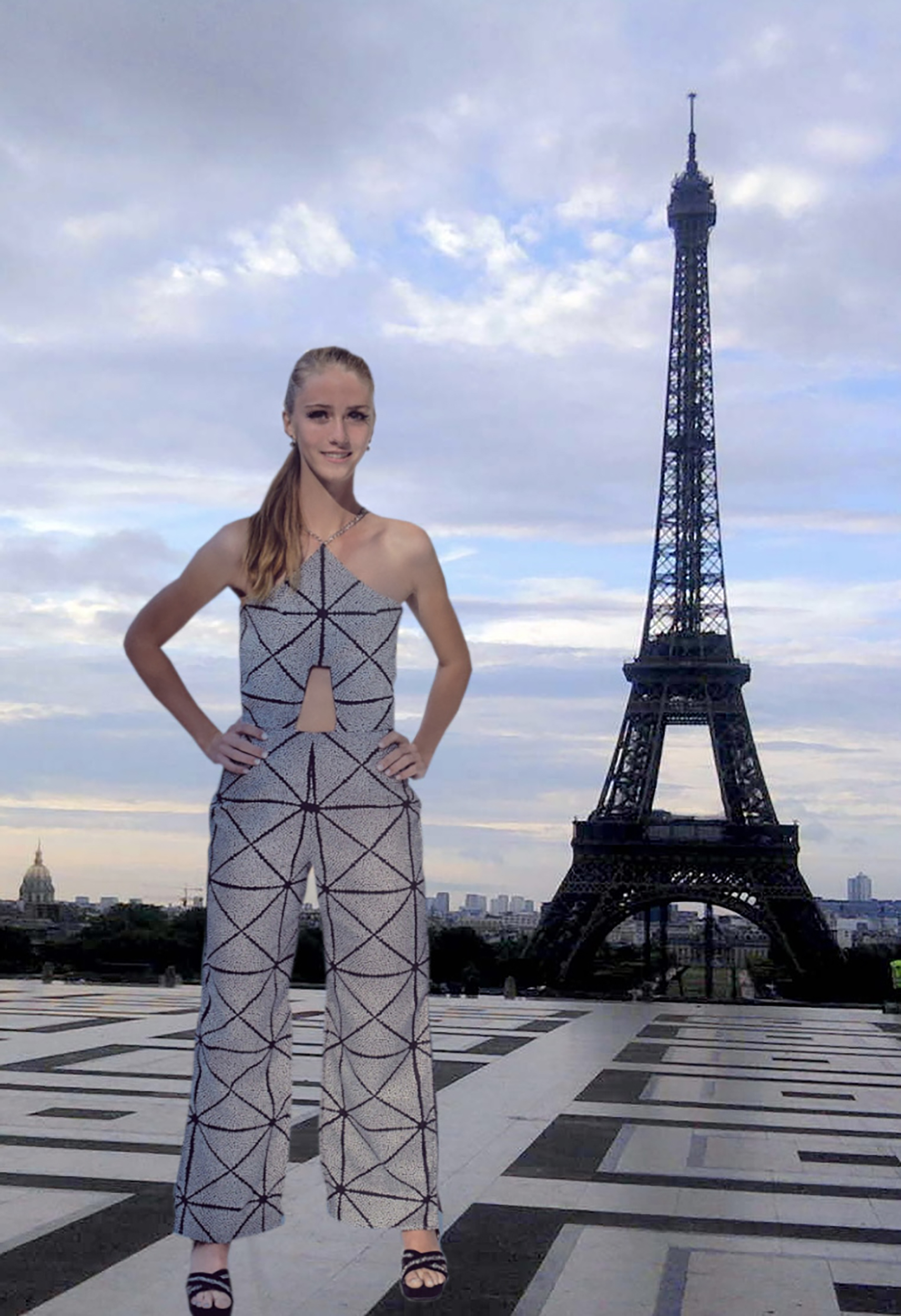 Girl standing in black and white jumpsuit in front of the Eiffel Tower