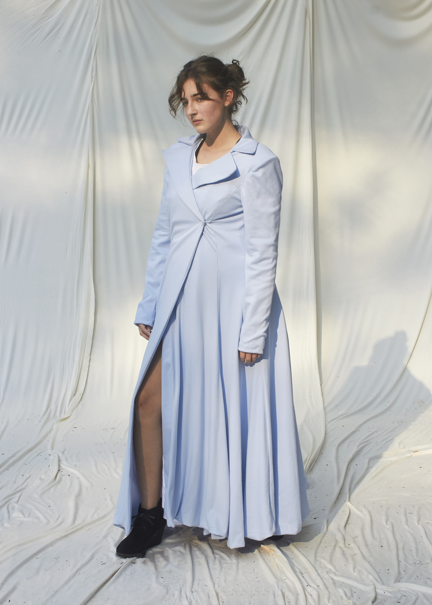 Photo of girl posing on long sleeve floor length sky blue coat 