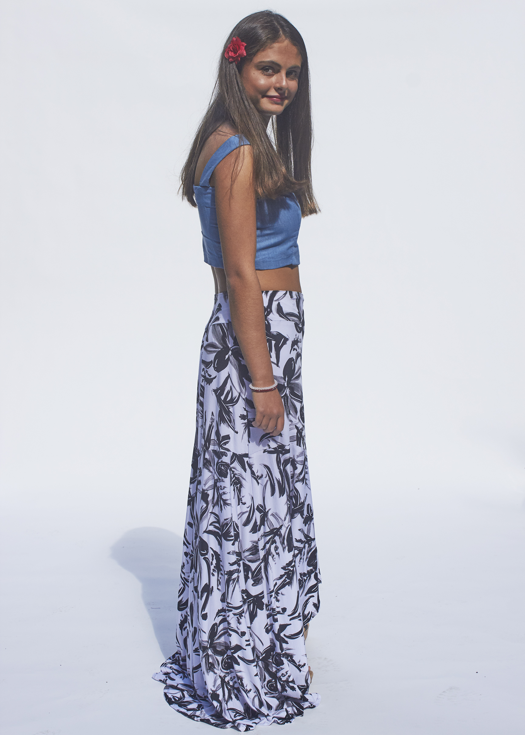 Side view of black and white floral skirt and denim top