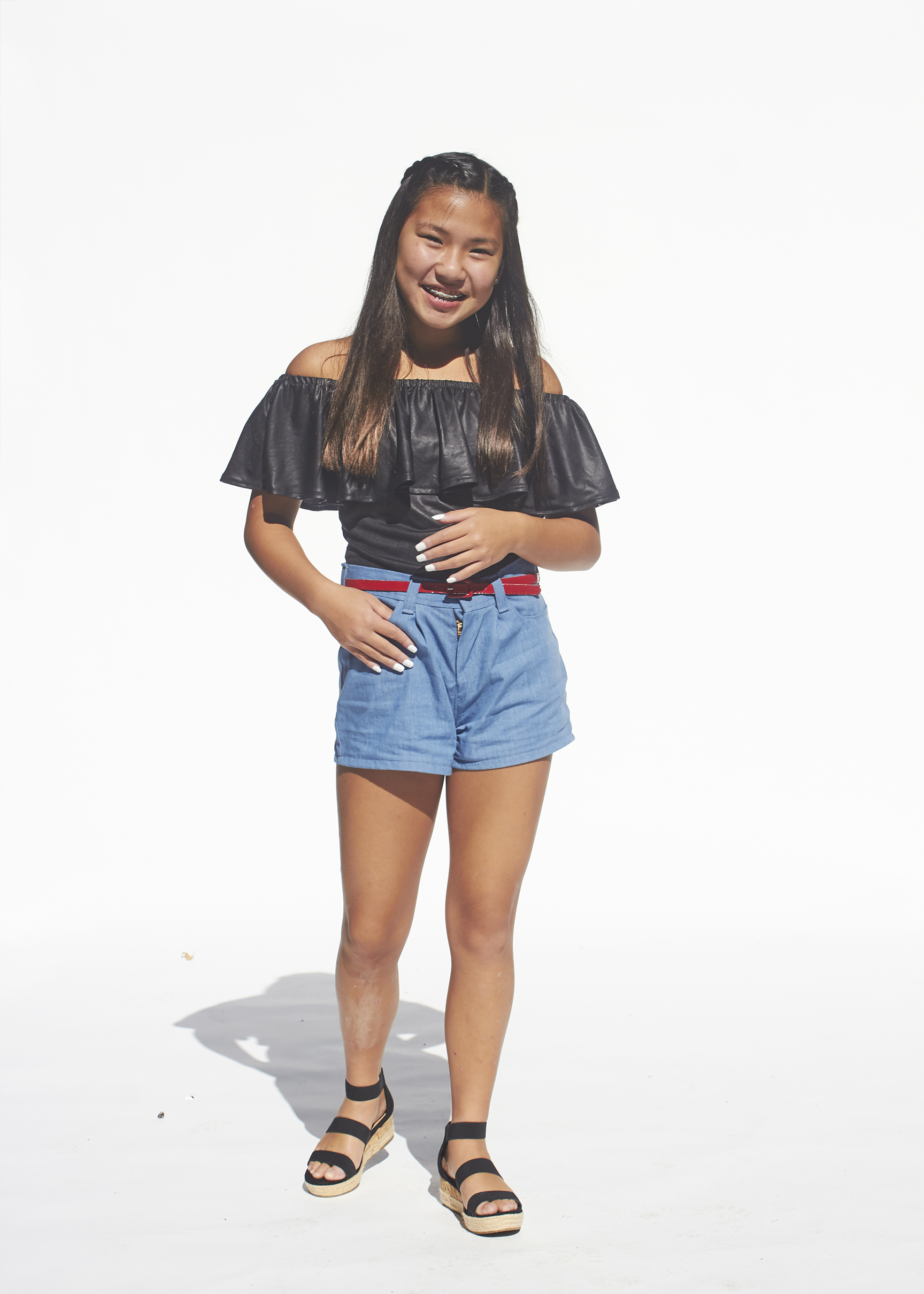 Photo of denim shorts and black flounced top 