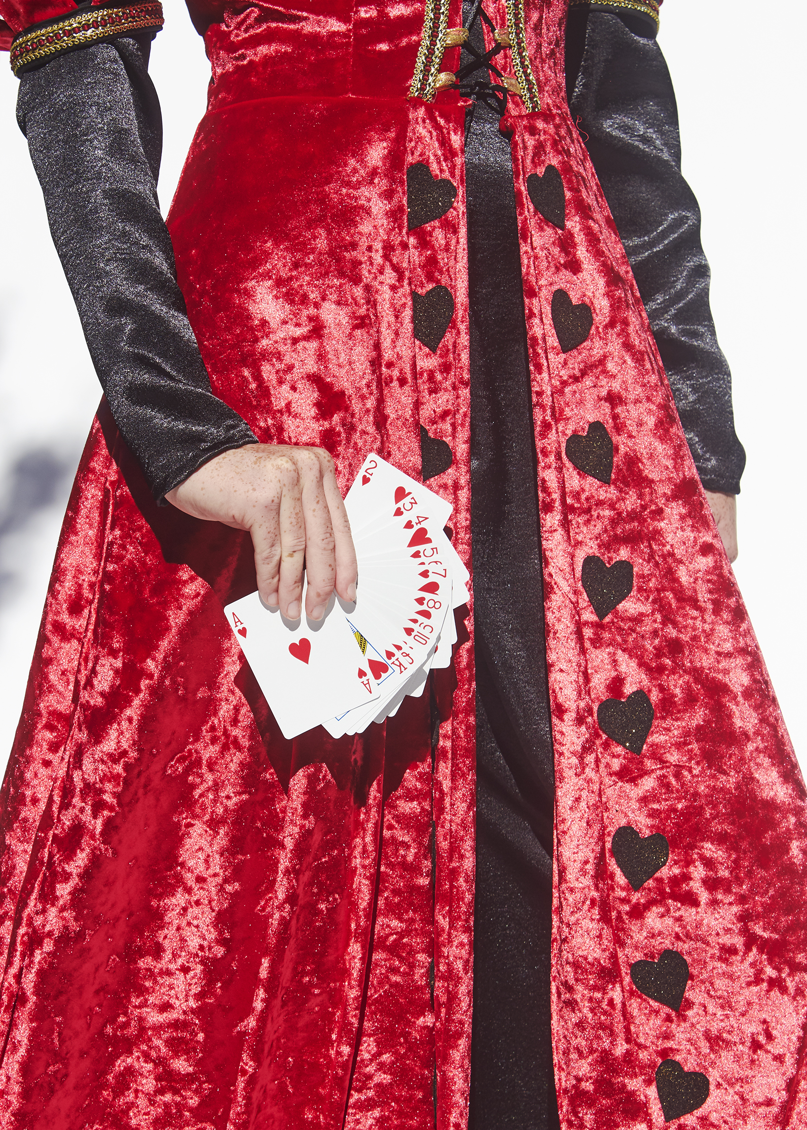 Detail photo of Queen of hearts costume with red velvet skirt with ironed on black hearts