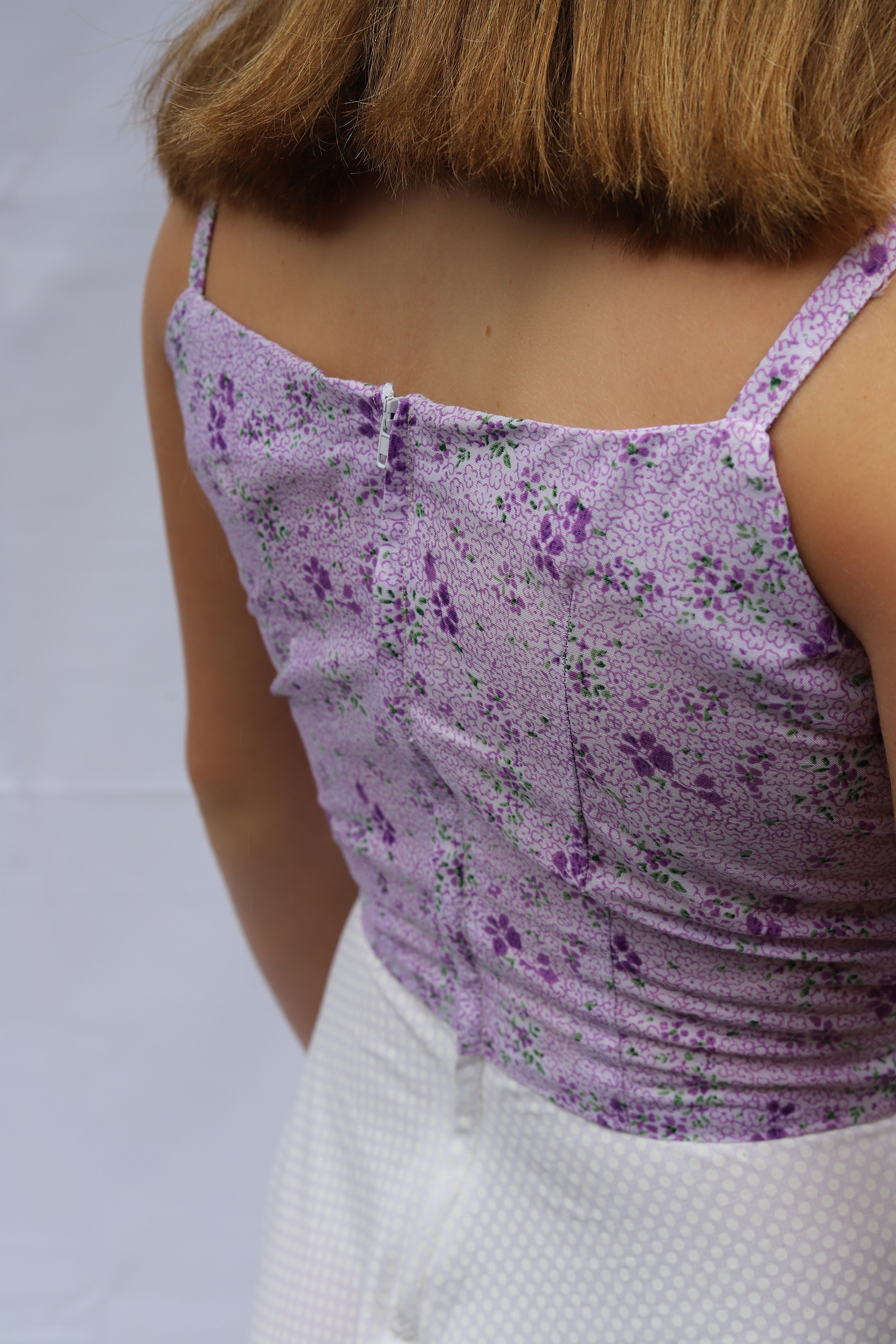 Detail shot of the back of a purple floral top