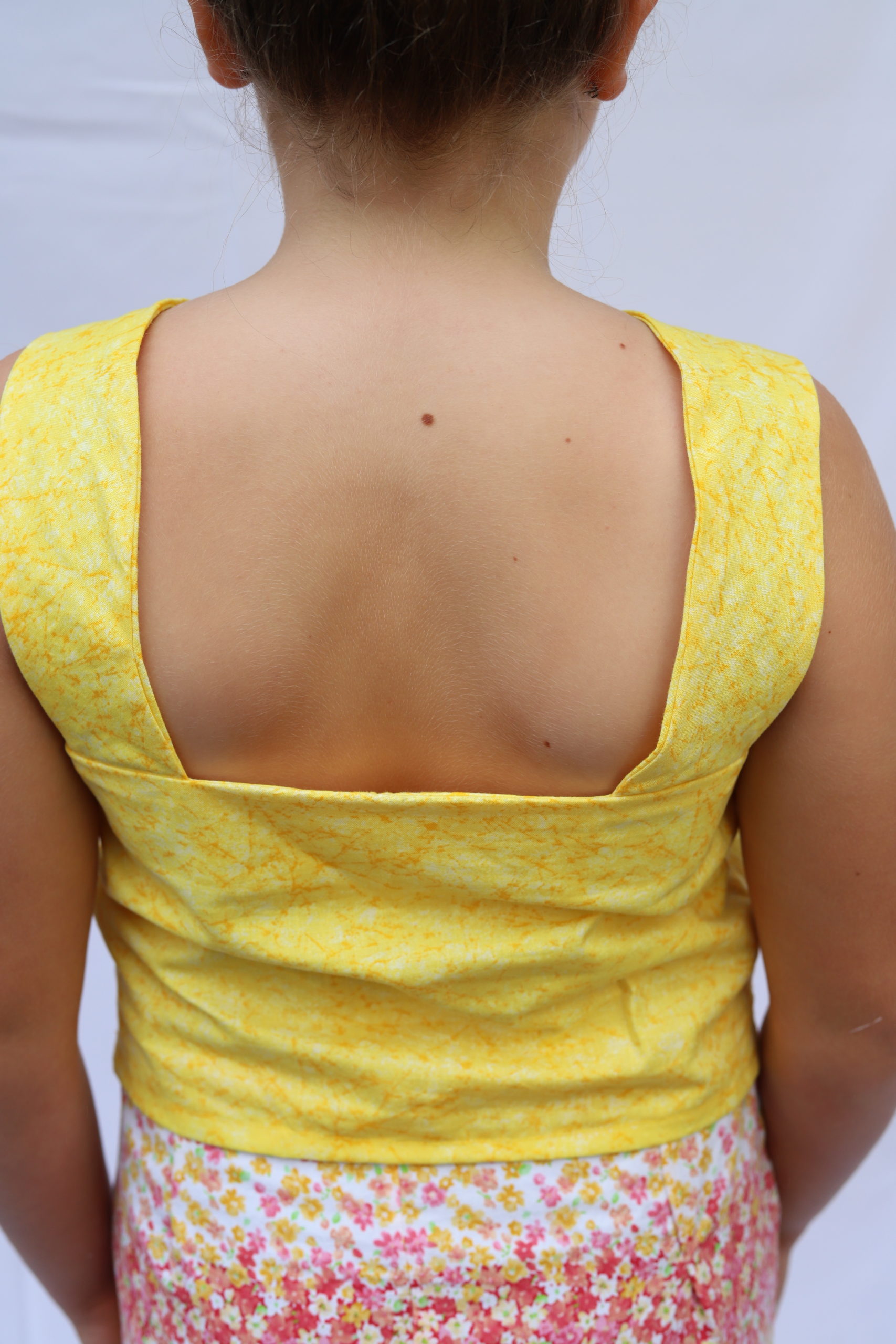 Close up photo os square back bright yellow top