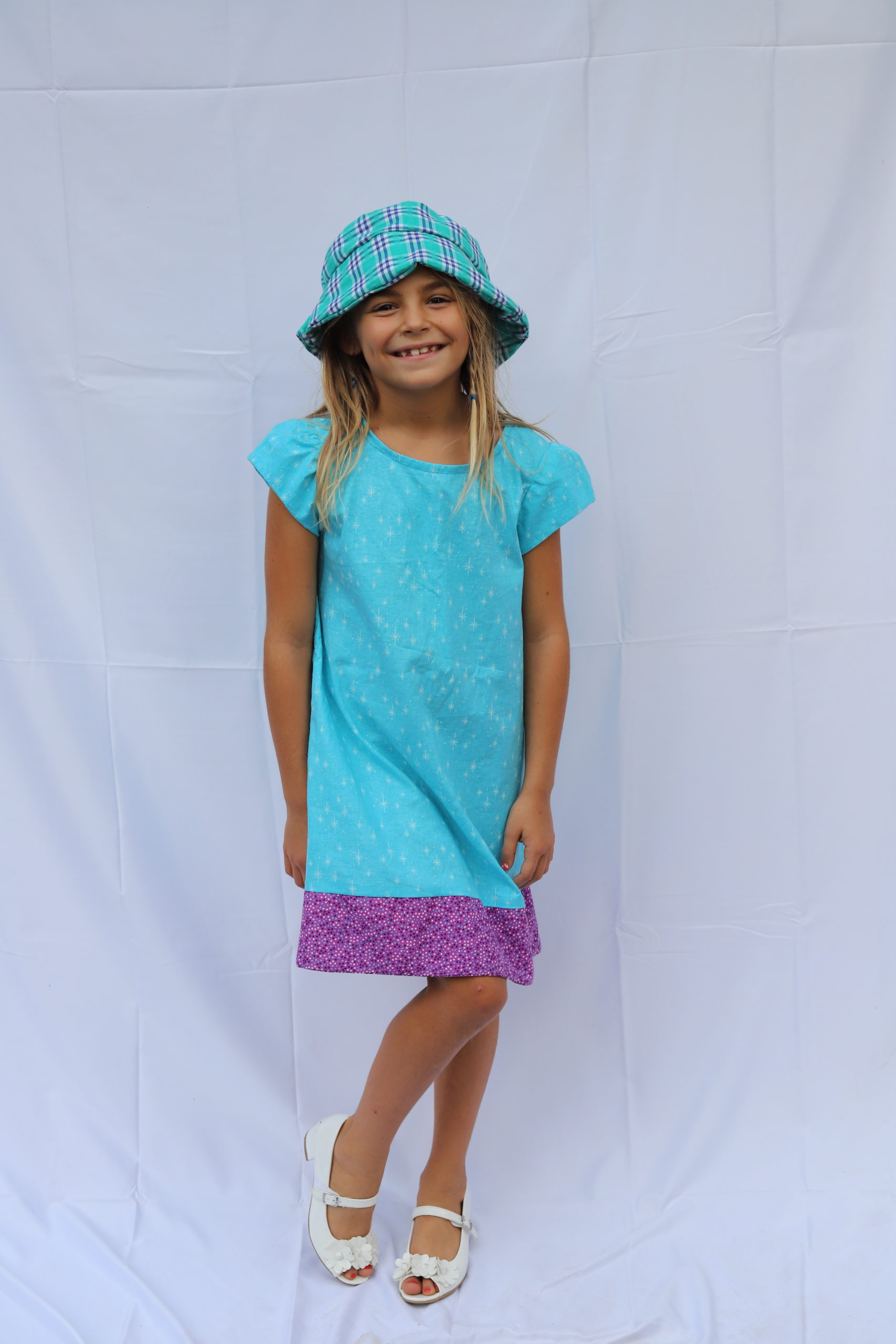 Photo of girl in aqua summer dress with purple trim