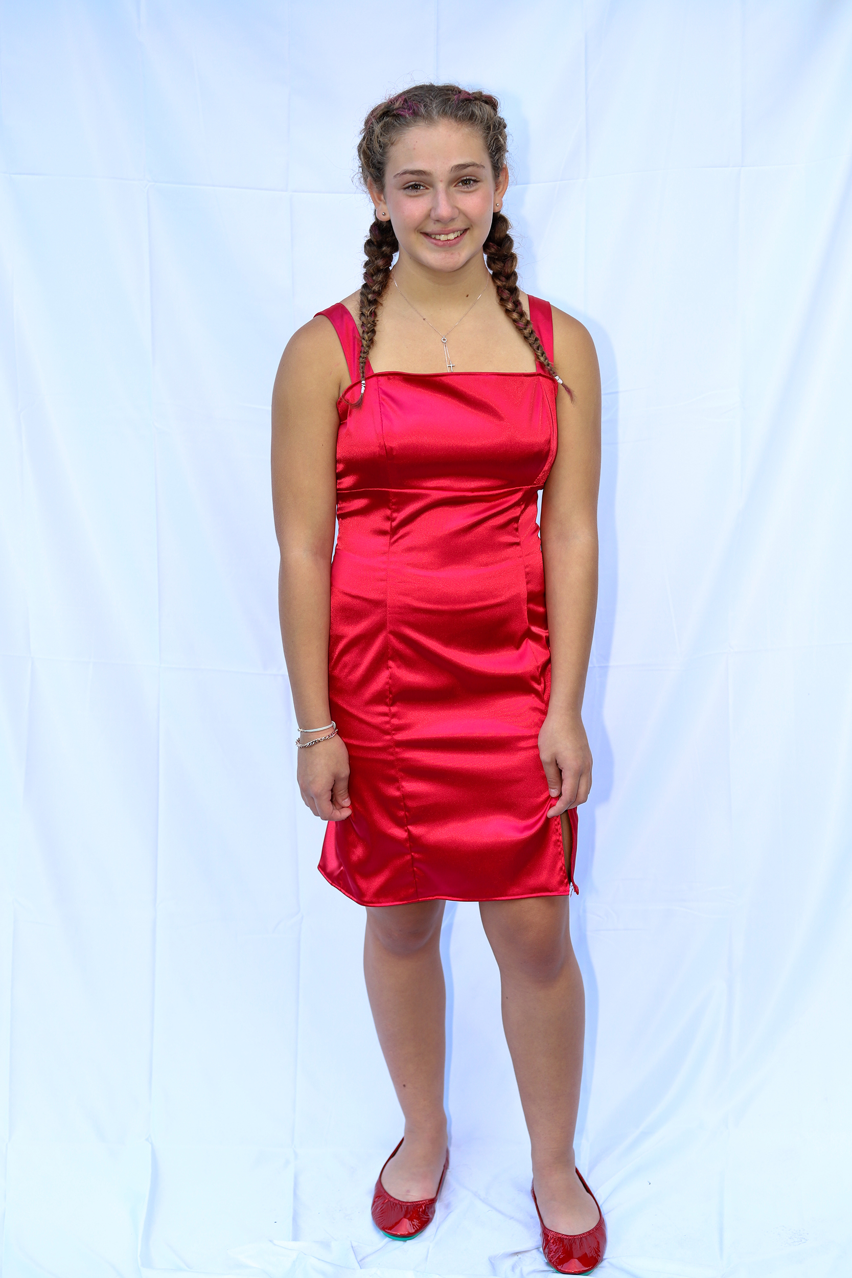 Girl standing in bright red satin body con dress