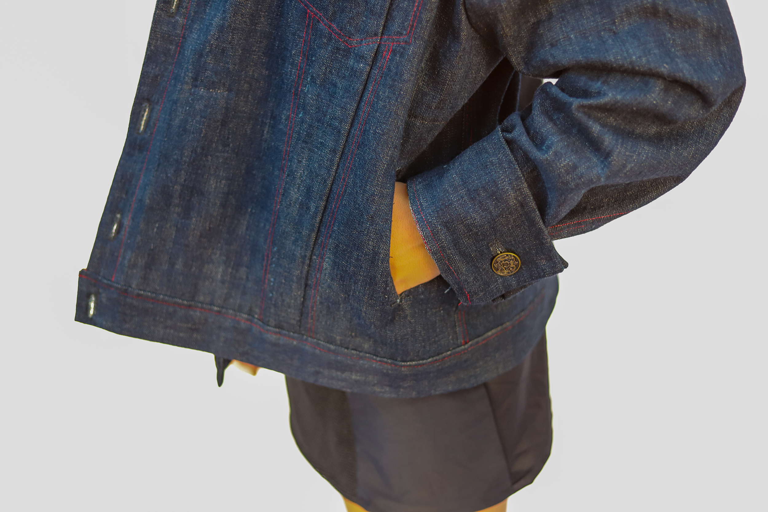 Close up photo of hand going into a denim jacket