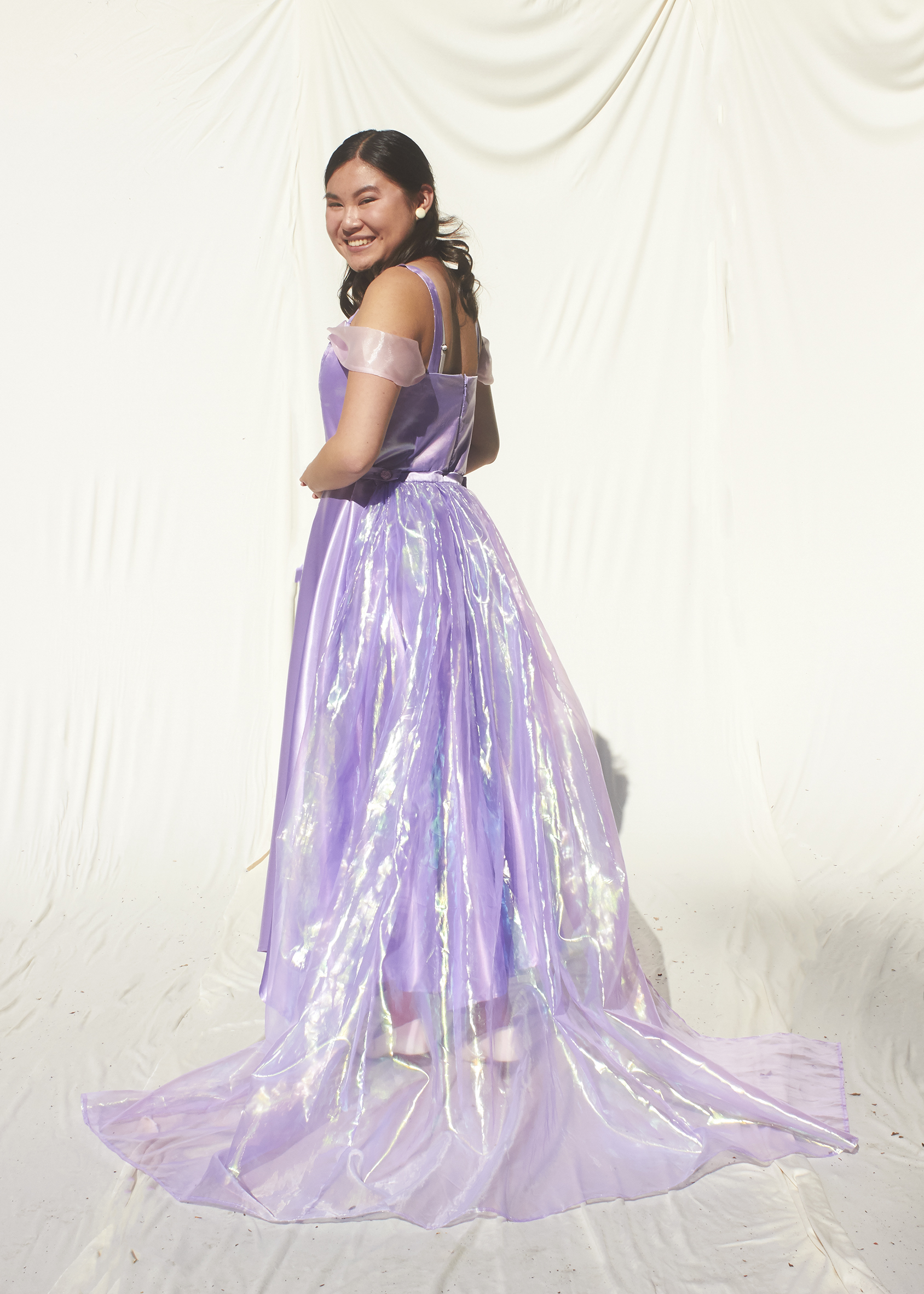 Girl in Rapunzel lavender tea length gown with sheer train