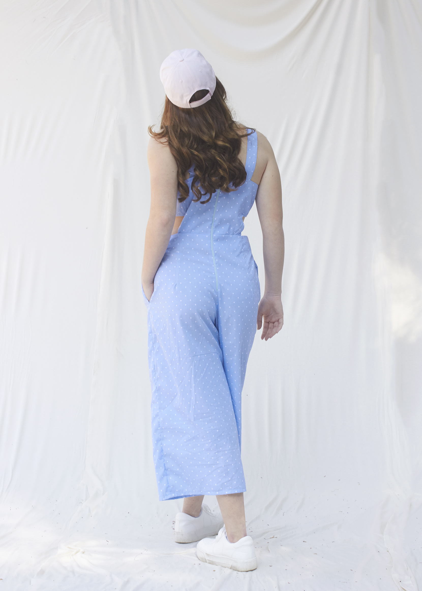 Back view of light blue and small white polka dotted jumpsuit