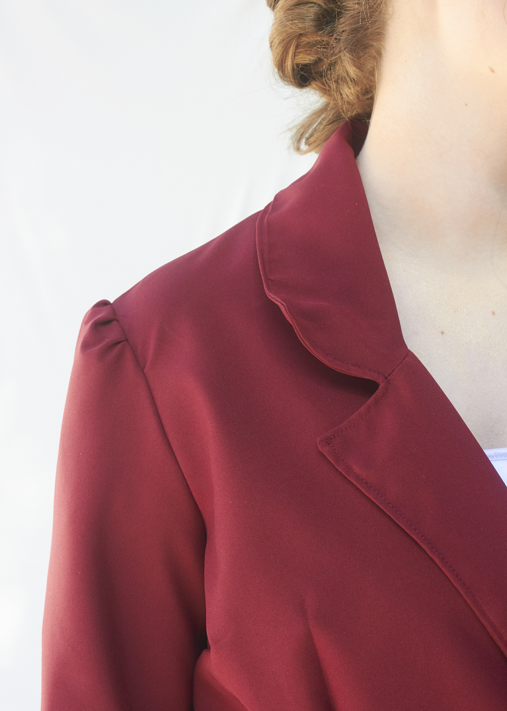 Close up photo of burgundy pointed collar