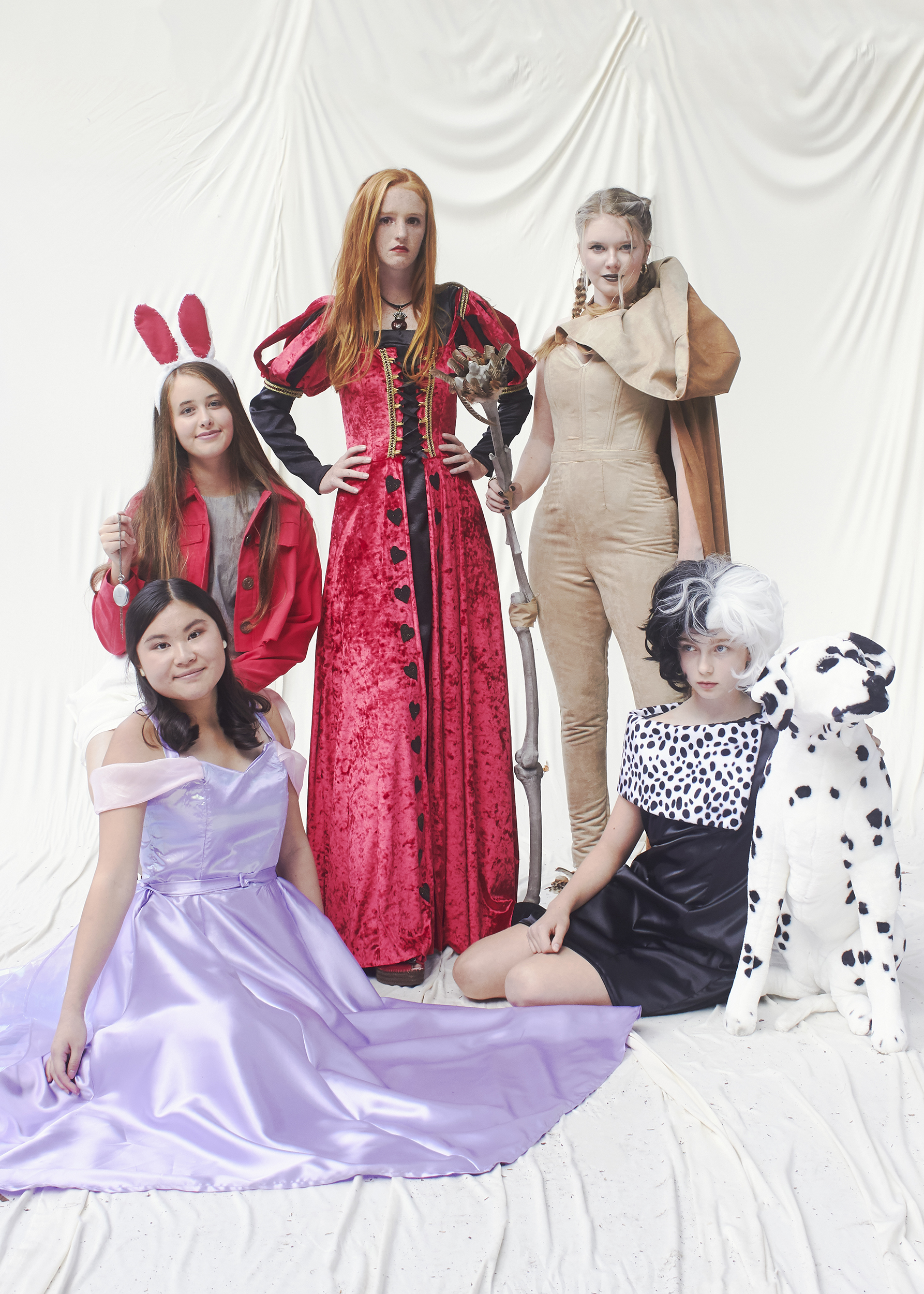 Five girls dress as disney characters. (From left to right there is Rapunzel, White Rabbit, Queen of Hearts, Scar, and Cruella Deville)