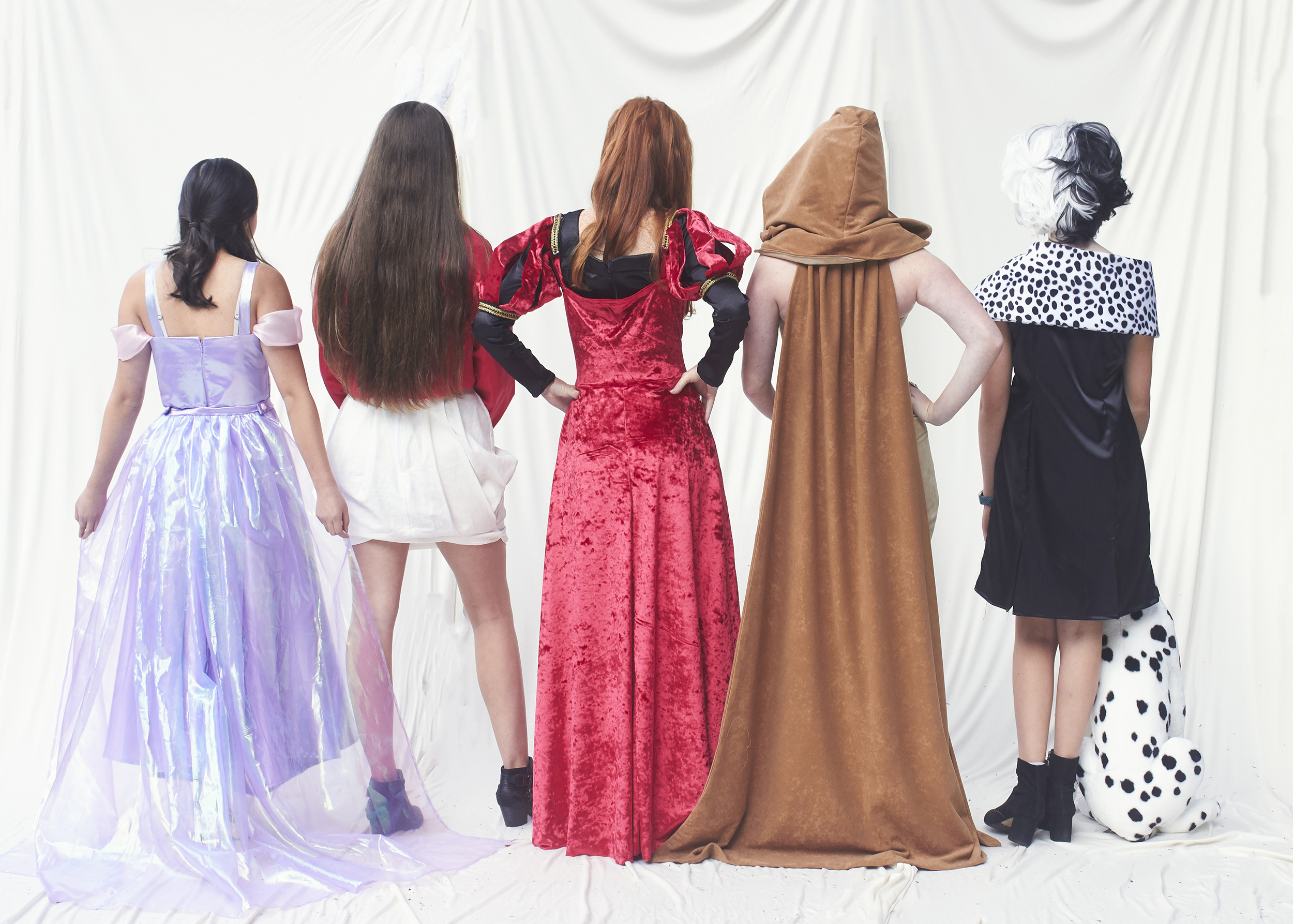 Back shot of girls in Disney costume. (From left to right there is Rapunzel, White Rabbit, Queen of Hearts, Scar, and Cruella Deville)