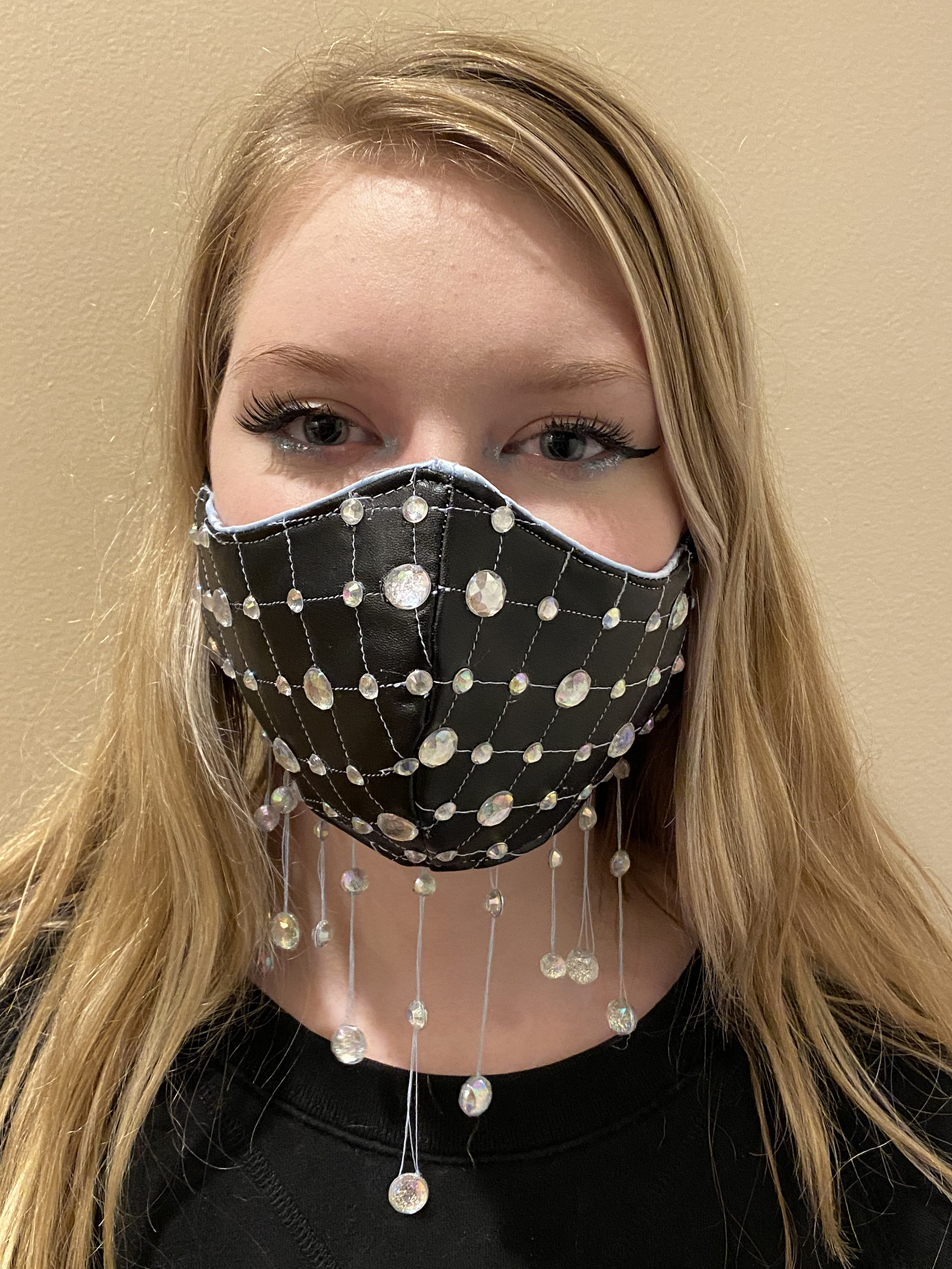 Girl posing in black quilted face mask 