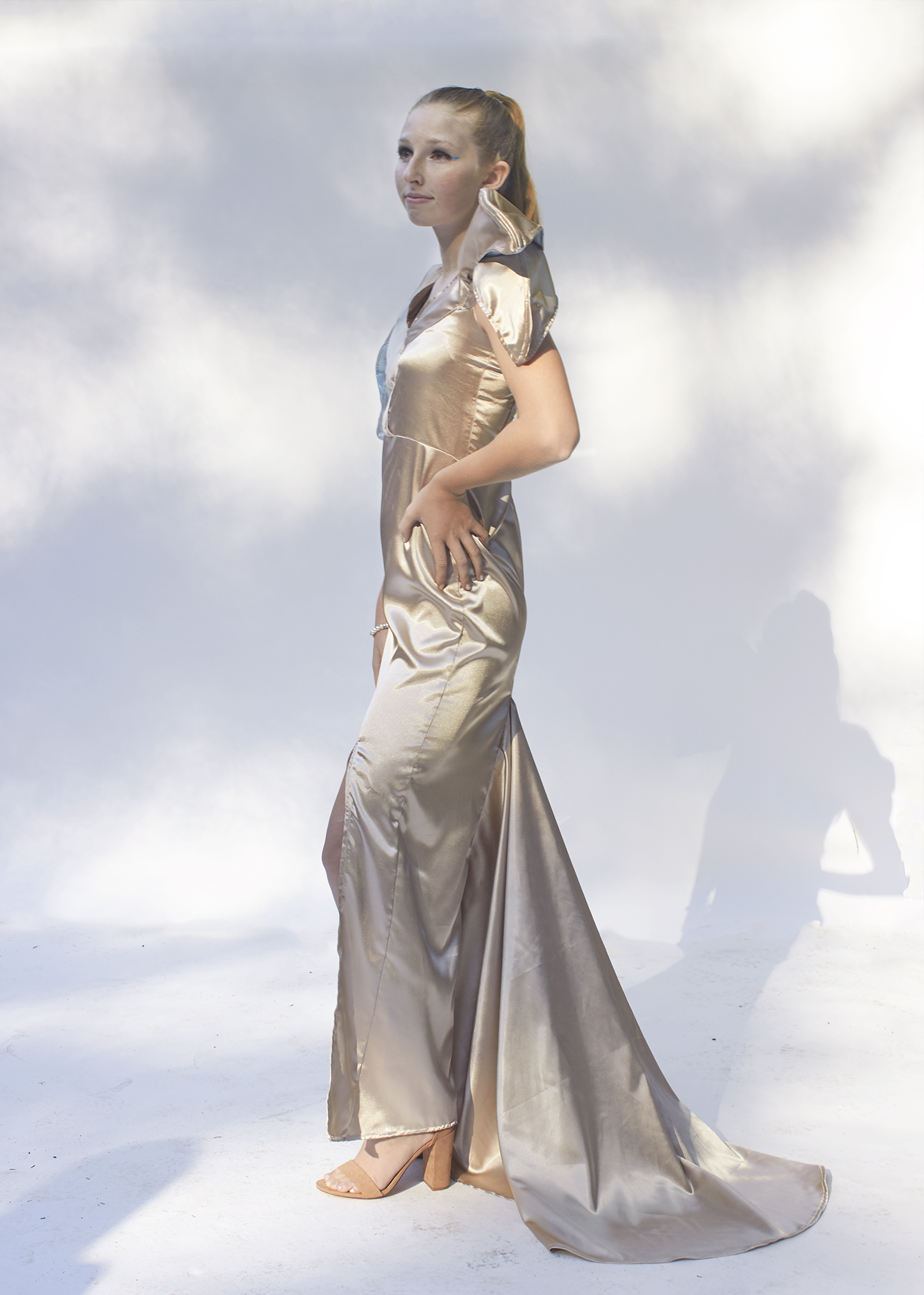 Side View of gold gown with large trumpet train