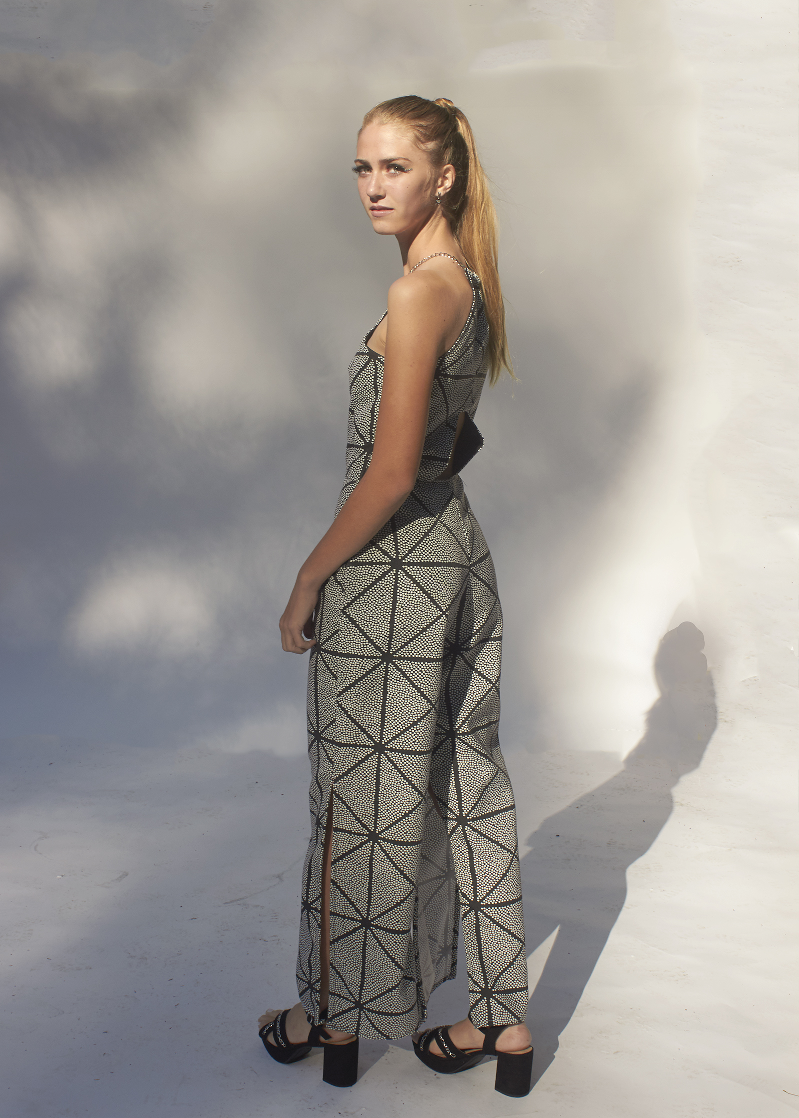 Back view of black and white geometric jumpsuit