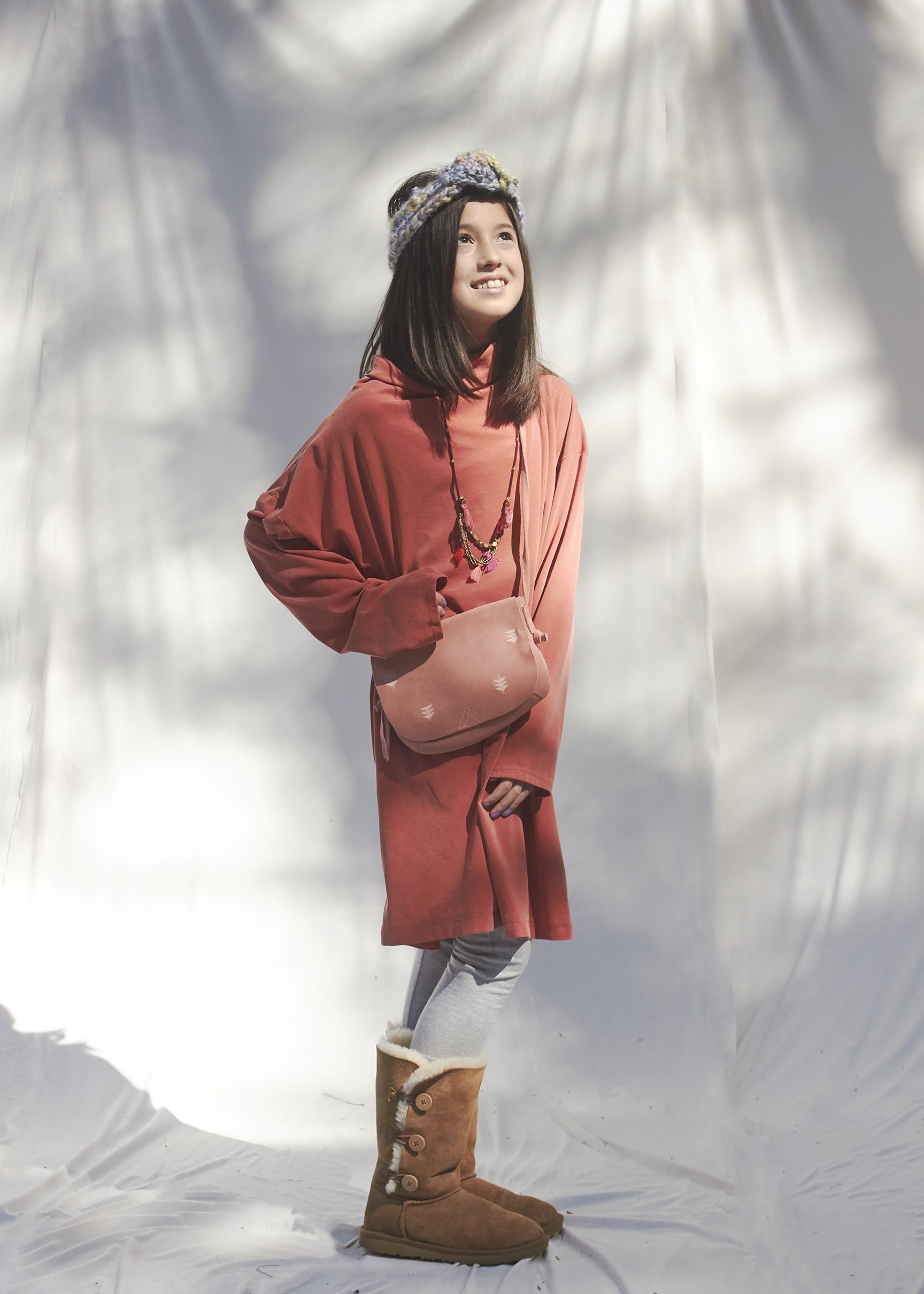 Girl standing in oversized rust orange sweater dress