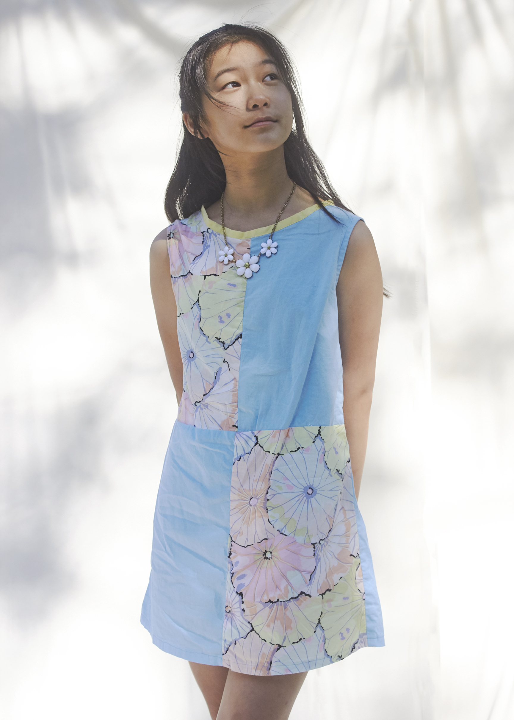 Close up view of a girl wearing a pastel color blocked dress