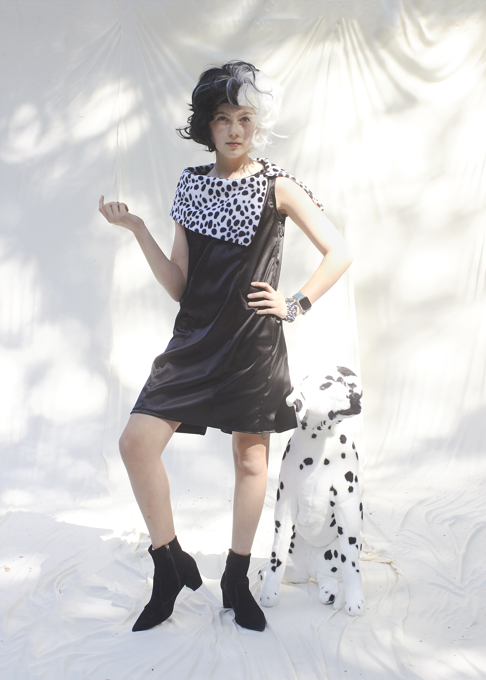 Girl posing in black satin dress with fur trim