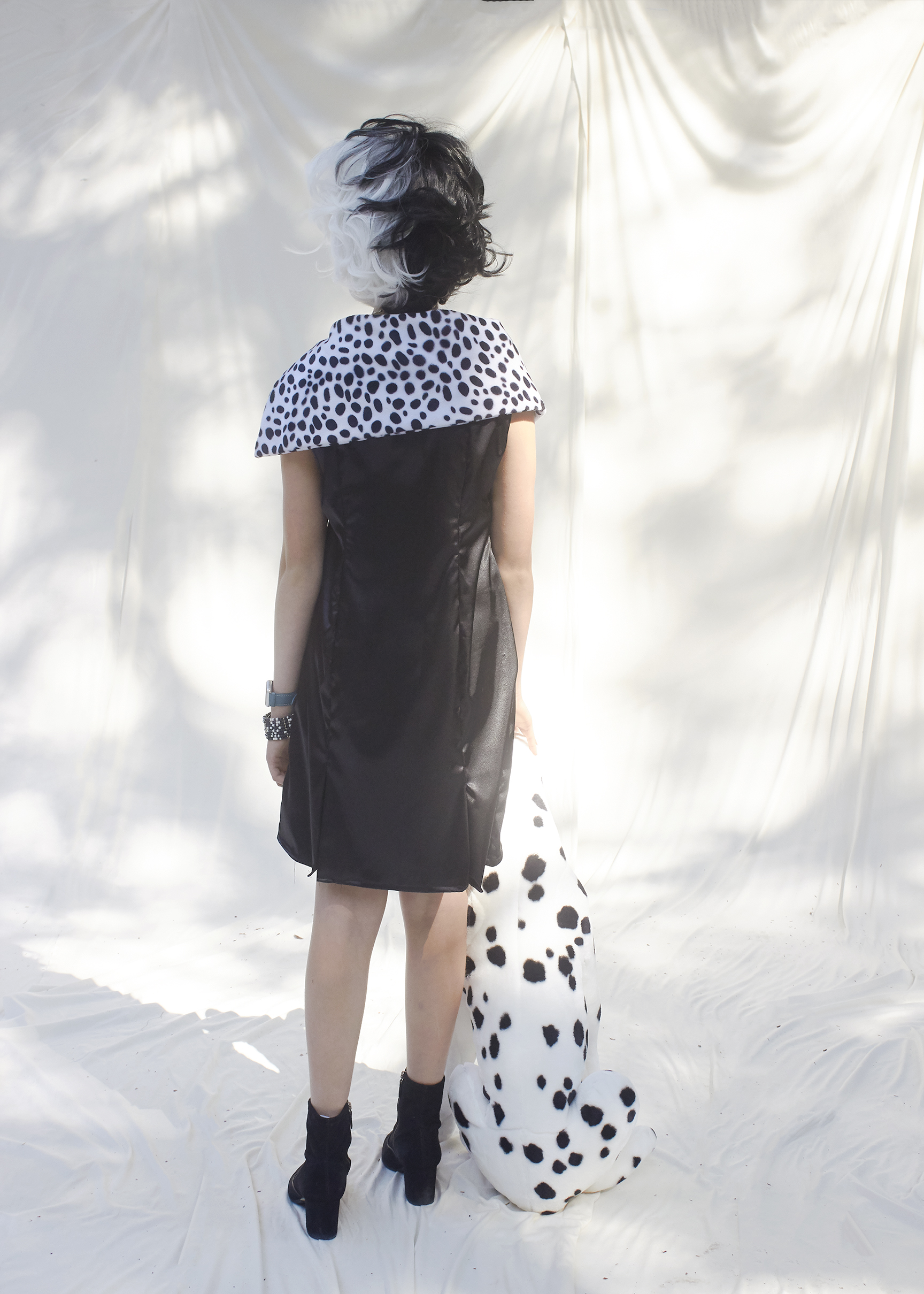 Back View of black satin dress with spotted fur trim collar