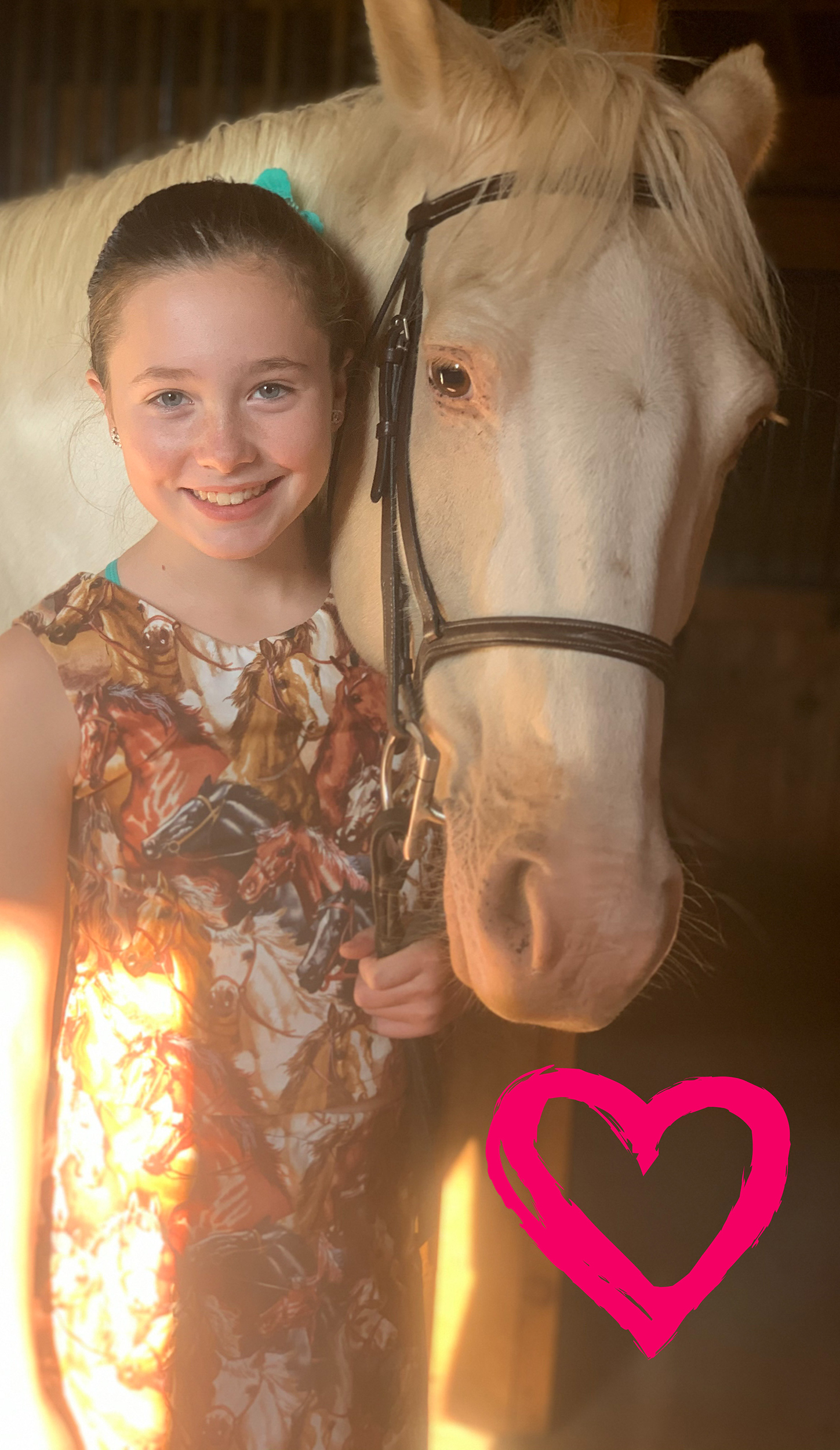 Girl standing in horse print top with her horse