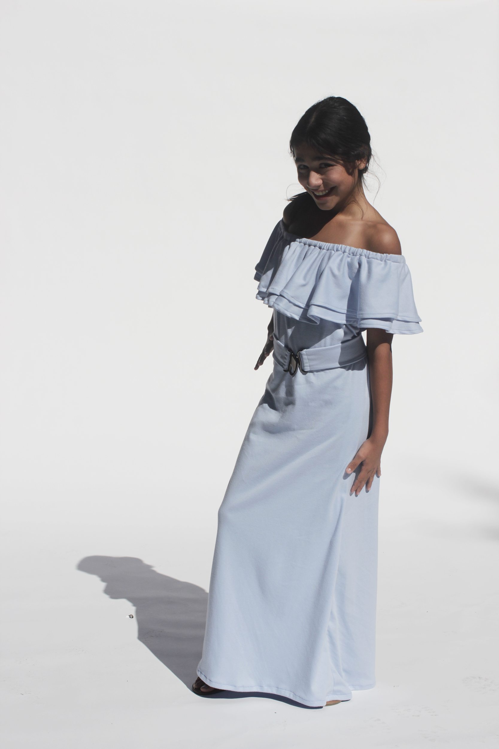 Girl posing in sky blue floor length dress with ruffled bodice