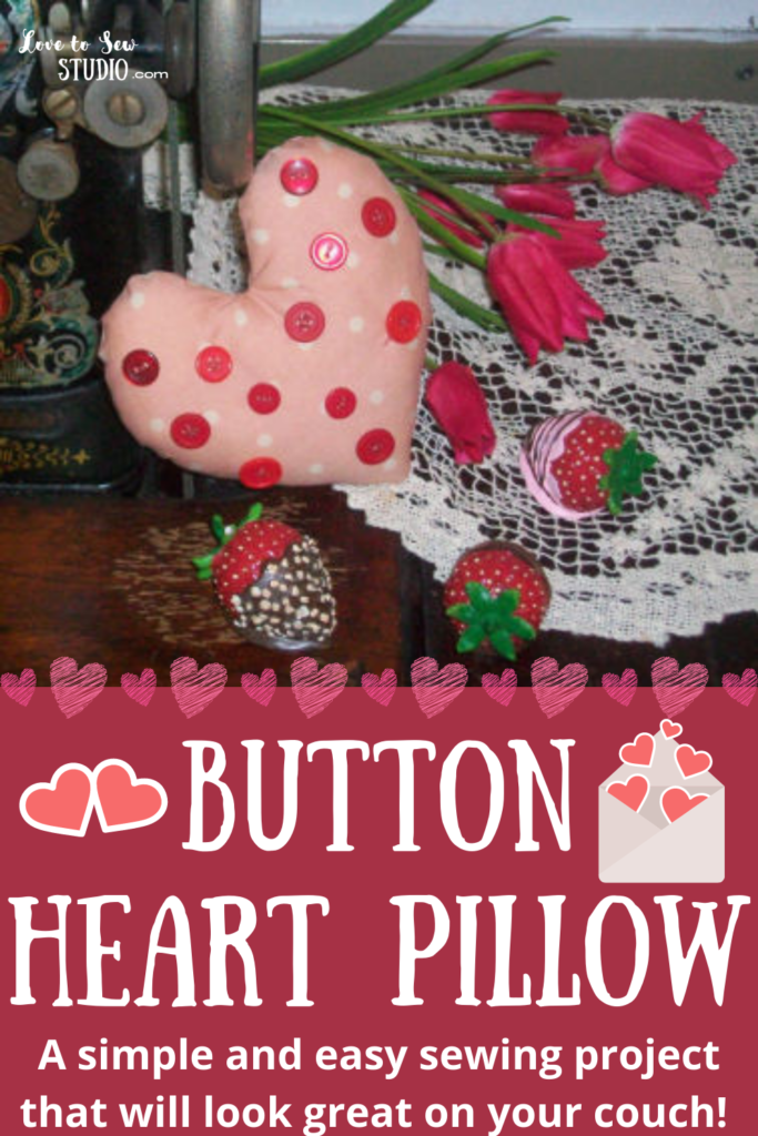 fabric pillow made into a heart with buttons all over it